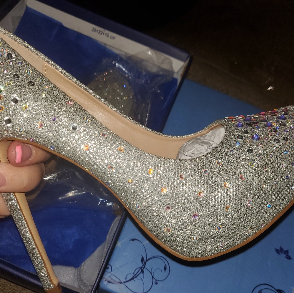 Brand new in box with storage bag.Beautiful silver with diamonds heels/stilettos